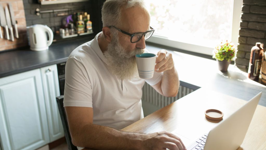 Man doing online research before calling a muscle car restoration shop